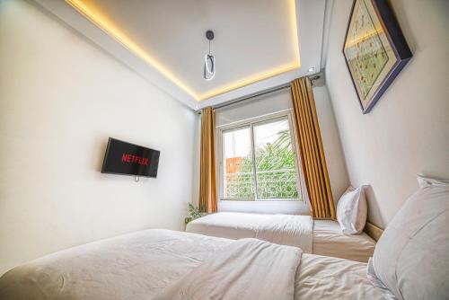 a bedroom with two beds and a window at Chic & Cozy Retreat in Agadir in Agadir