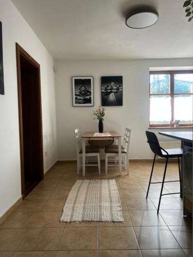 a kitchen and dining room with a table and chairs at Apartmán 2 jeseň-zima in Martin