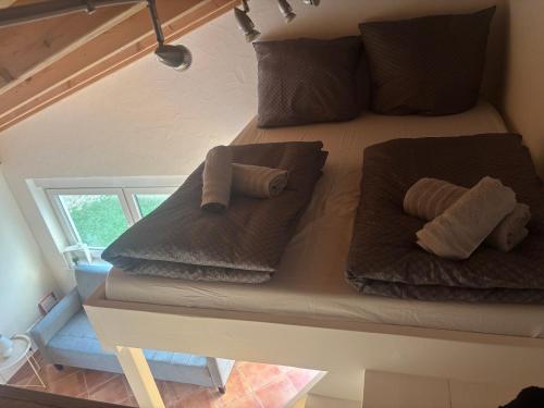 a bed with towels and pillows on it in a room at Steffis Appartement in Wiesbaden