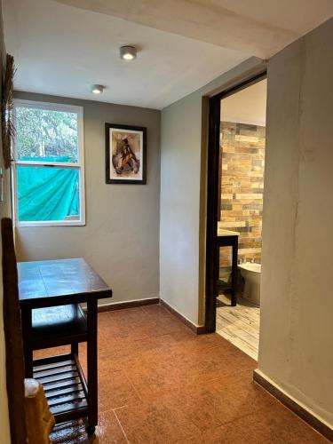a dining room with a table and a window at Los ciruelos - Casas de Motaña in Tafí del Valle