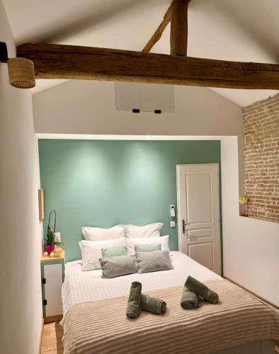 - une chambre dotée d'un grand lit avec deux paires de chaussures dans l'établissement Bétia Cocoon SPA et Sérénité, proche Canal du Midi, à Grisolles