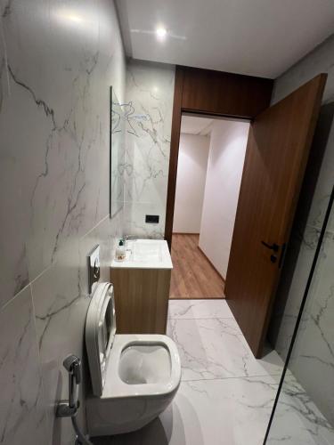 a bathroom with a toilet and a sink at Casablanca Finance City 33 Tower in Casablanca