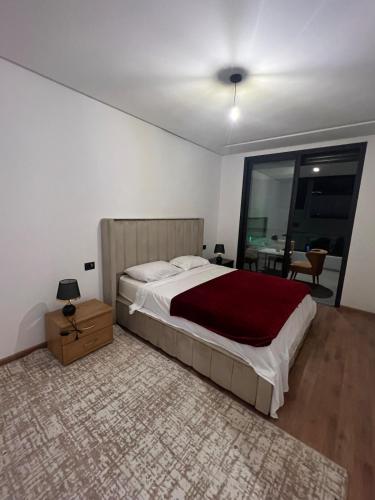 a bedroom with a large bed and a table at Casablanca Finance City 33 Tower in Casablanca