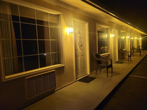 a hallway of a house with chairs and a door at Fox Mountain Inn in Max Meadows