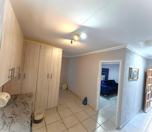 a room with a ceiling fan and a living room at Azrisi Apartments in Kempton Park