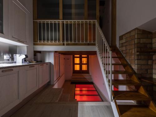 a staircase in a kitchen with a red rug on the floor at Karalis Relais in Cagliari