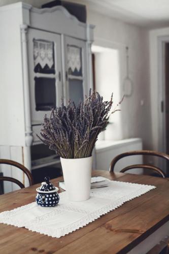 a table with a vase with purple flowers on it at Lavendowo in Piechowice
