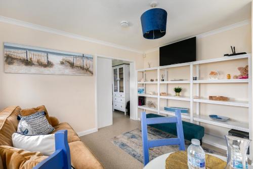 a living room with a couch and a table at Rural 7 and 2 bed Lodge stays In Windsor! Hot Tub! Sleeps 20 in Bray