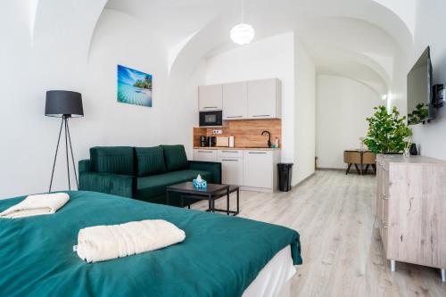 a bedroom with a green bed and a living room at Luxapart V Beautiful Views with Breakfast in Košice