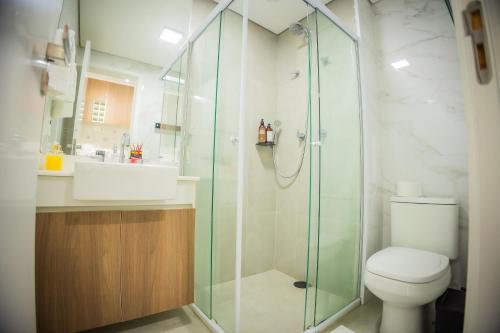 a bathroom with a shower and a toilet and a sink at 2206 - Studio | alto padrão in Guarulhos