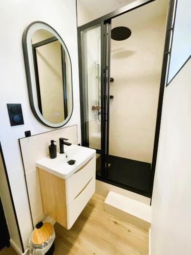 a bathroom with a sink and a shower at La Villa Bligny in Étretat