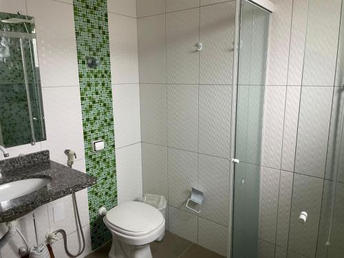 グァラトゥバにあるCasa surfのトイレとガラスのシャワー付きのバスルーム