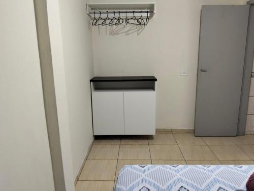 cocina con fogones y nevera en una habitación en Home Portal do Aconchego, en Foz do Iguaçu