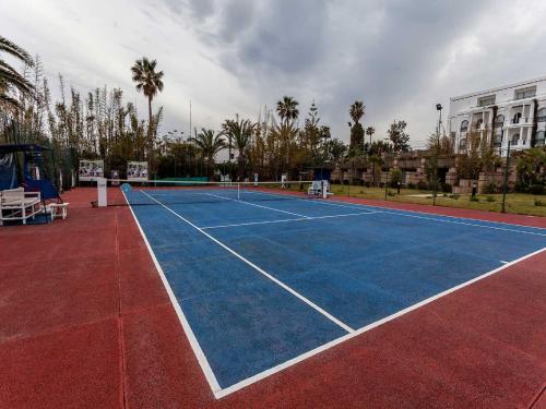 a tennis court with a tennis net on it at Marina Smir Hotel & Spa in M'diq