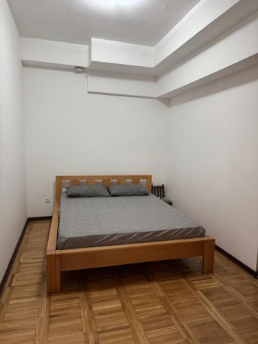 a bedroom with a bed in a white room at Gemelli in Igalo