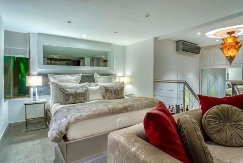 a bedroom with a large bed and a couch at Atlanticview Cape Town Boutique Hotel in Cape Town