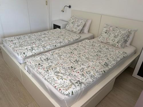 two beds sitting next to each other in a bedroom at apartmant Adrian Vista Taurito in Taurito