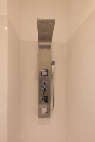a bathroom with a shower with a soap dispenser on a wall at Wagner Villa 902 with free private parking in Budapest