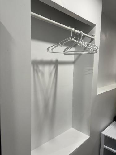 a white closet with a hanger in it at Bachelor and Double room in Bedford, Halifax in Halifax