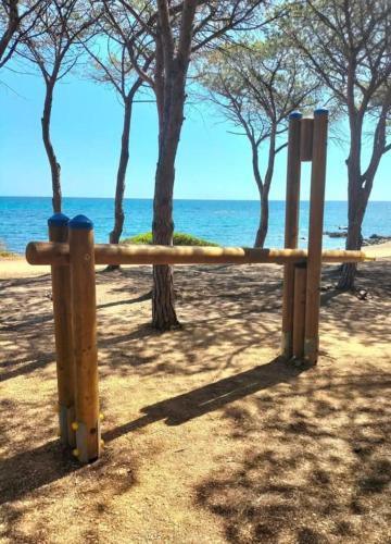 a wooden fence on the beach near the water at Gli Ulivi in Budoni