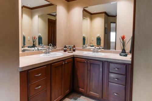 a bathroom with two sinks and two mirrors at CR Luxury Veranda 7B 2 Bdrm in La Mona