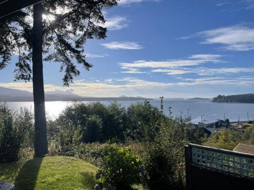 a view of a body of water with a bench at Seine Boat Inn in Alert Bay