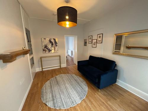 a living room with a blue couch and a rug at Chalkwell Aparthotel Short & Long Stays Welcome, Leisure , Relocation , Business Stays , Contractors in Kent