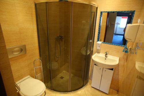 a bathroom with a shower and a toilet and a sink at HELLO Gdynia Hostel in Gdynia