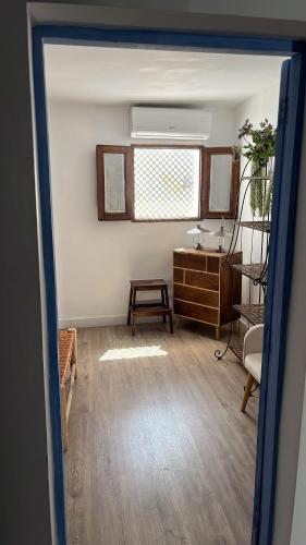 a living room with a desk and a window at LAZURITE MASPALOMAS Apartamentos Sur Gran Canaria in Maspalomas