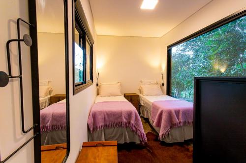 Ένα ή περισσότερα κρεβάτια σε δωμάτιο στο Rancho Conteiner