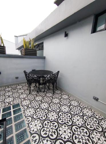 a patio with a bench on a tile floor at Eurolan 72 in Bogotá