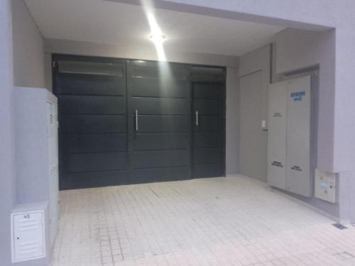 an empty room with a garage with a sliding door at URIBURU 45 in Malargüe