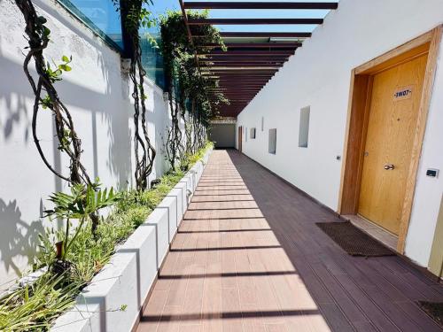 a corridor of a building with plants on the wall at Prestige apartment, Tamaris, sea view in Tamaris