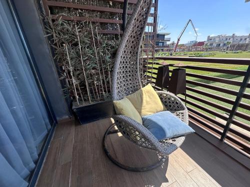 a wicker chair sitting on a balcony at Prestige apartment, Tamaris, sea view in Tamaris
