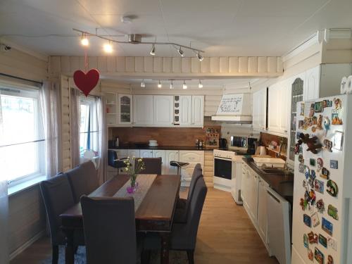 a kitchen with a wooden table and a refrigerator at Holiday Home Villa Gol in Gol