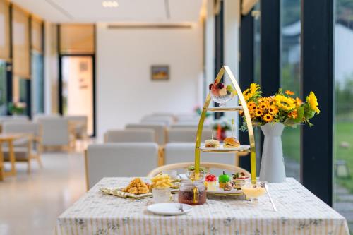 a table with a plate of food on it at Dongqian Lake Junlan Resort Hotel in Ningbo
