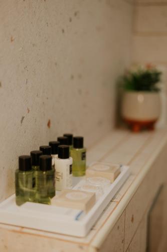 a counter top with bottles of cosmetics on it at Goland Hotel in Mas'ade