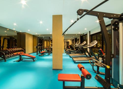 a gym with rows of treadmills and machines at Dongqian Lake Junlan Resort Hotel in Ningbo