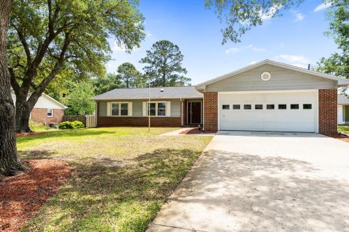 a house with a driveway and a garage at Beach & Downtown Family Fun Wilmington Stay Villa in Wrightsville Beach