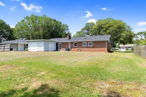 a house with a yard in front of it at Beach & Downtown Family Fun Wilmington Stay Villa in Wrightsville Beach