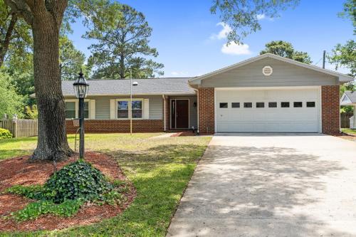 a house with a tree and a driveway at Beach & Downtown Family Fun Wilmington Stay Villa in Wrightsville Beach