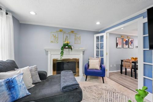 a living room with a couch and a fireplace at MdPulse 2BR Upper Suite Peaceful Retreat Near DC in Waldorf
