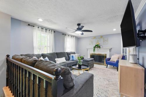 a living room with a couch and a tv at MdPulse 2BR Upper Suite Peaceful Retreat Near DC in Waldorf