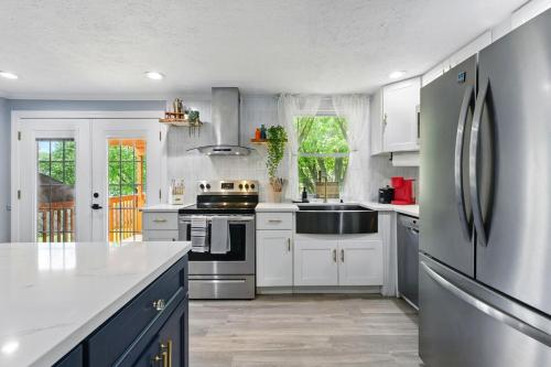 a kitchen with white cabinets and a stainless steel refrigerator at MdPulse 2BR Upper Suite Peaceful Retreat Near DC in Waldorf