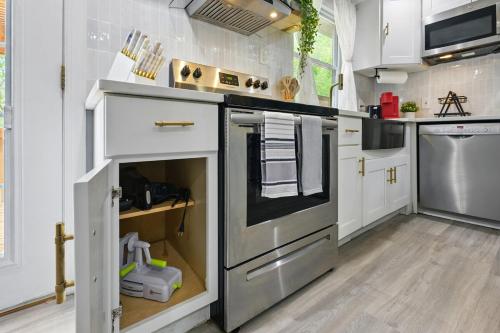 a kitchen with white cabinets and a stainless steel oven at MdPulse 2BR Upper Suite Peaceful Retreat Near DC in Waldorf