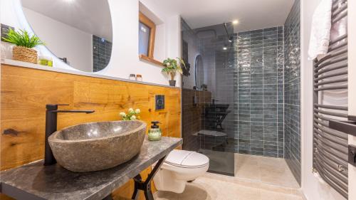 a bathroom with a sink and a toilet at Sun x Mountains - Old Town in Braşov
