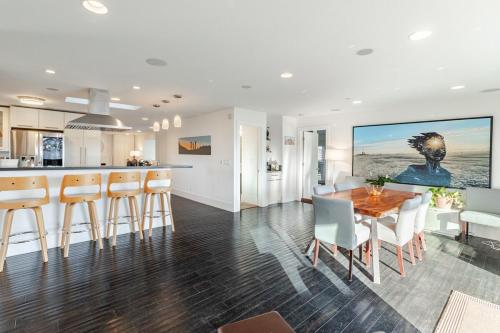 a kitchen and dining room with a table and chairs at Lagoon Living Offsite and Family Retreat! in San Mateo