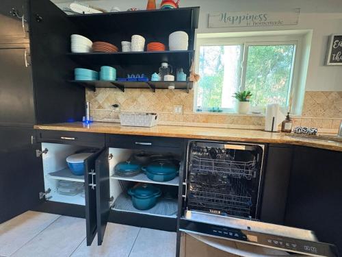 a kitchen with a counter with a dishwasher at 10 Min from Beach, Private Pool with Lanai Palm Coast Family Home in Palm Coast