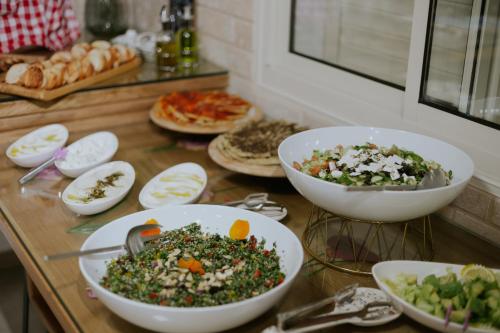 a table topped with bowls of food on a counter at Goland Hotel in Mas'ade