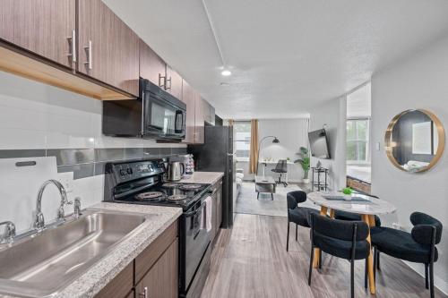 a kitchen with a sink and a stove top oven at Modern Stay Comfort-Free Parking in Cincinnati